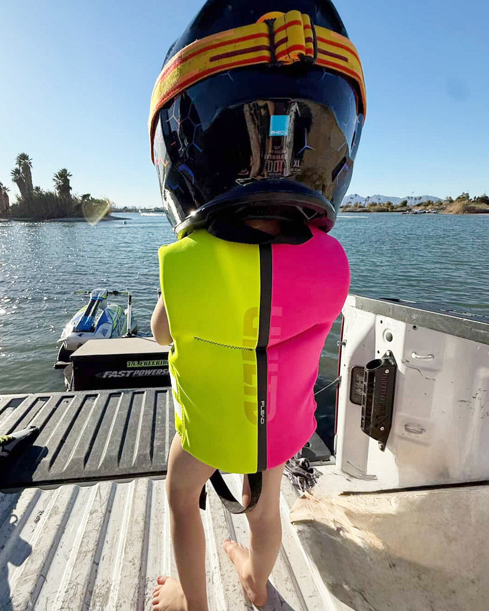 Child Neo Life Vest by Unlimited PWC, lightweight flotation vest with adjustable straps and bright safety colors for water safety.