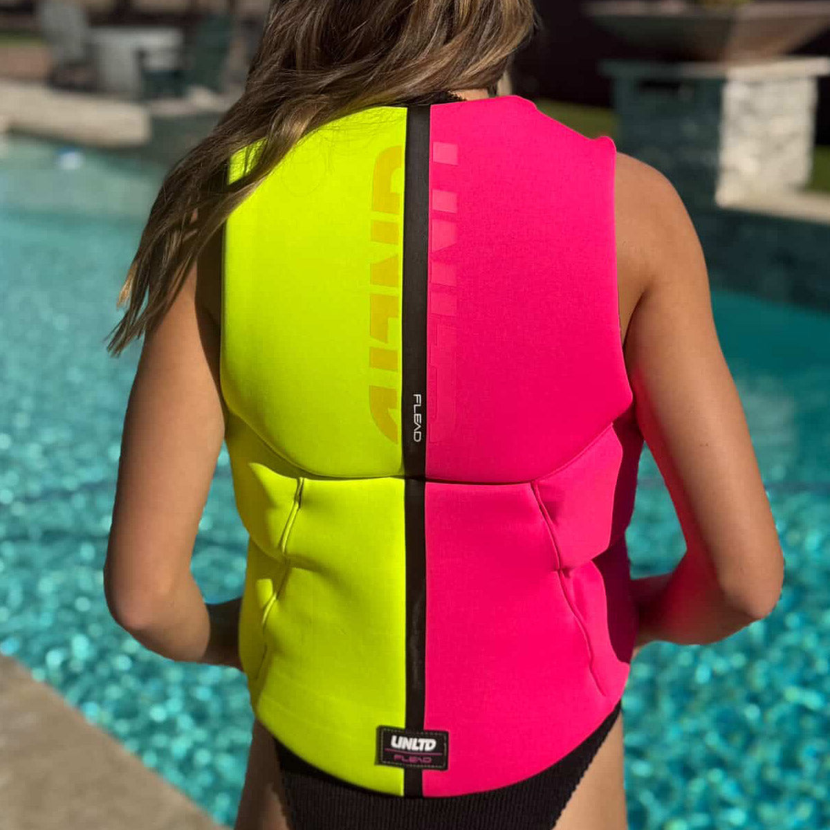UNLIMITED PWC FLEAD NEO VEST, a lightweight, high-performance personal watercraft life jacket with adjustable straps and bright color.